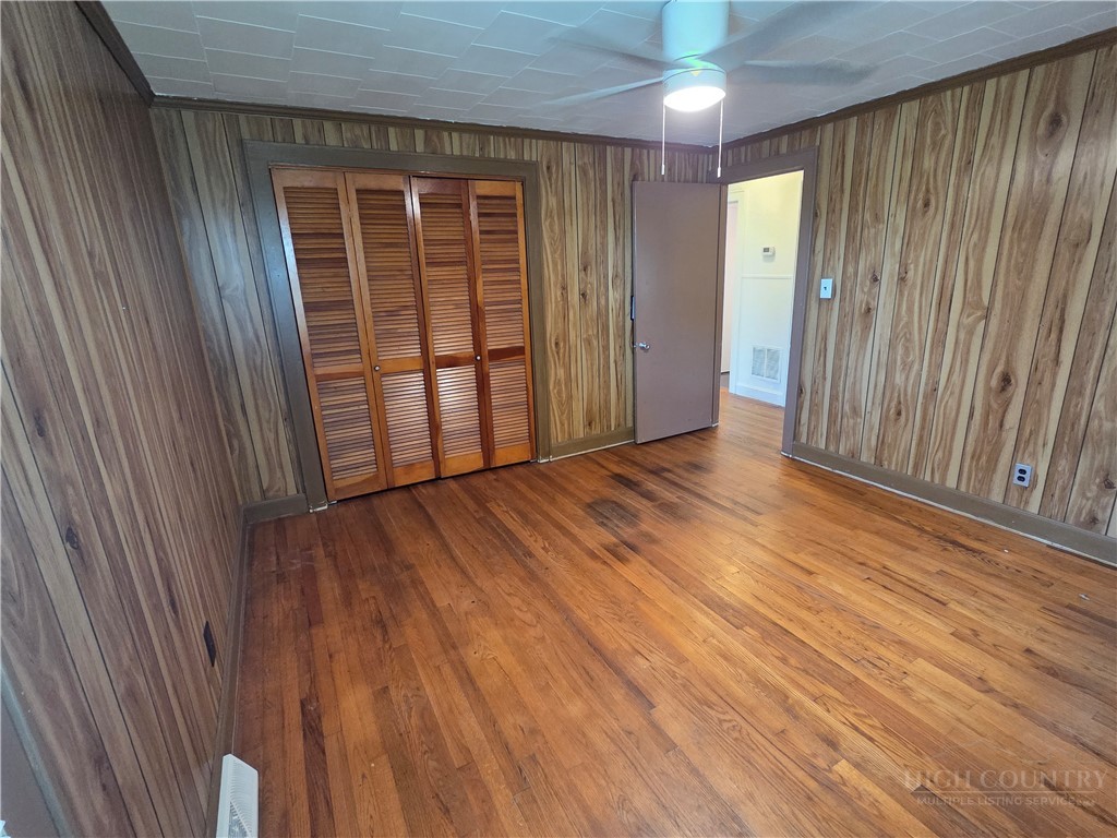 145 Black Oak Ridge Road Taylorsville, NC 28681 - Photo 27 of 39 an empty room with wooden floor and windows