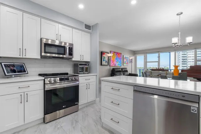 a kitchen with stainless steel appliances a refrigerator and a stove top oven