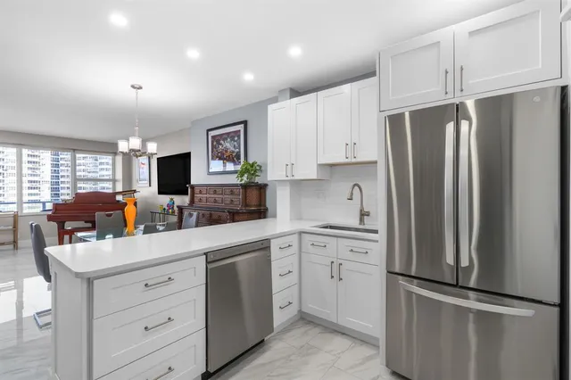 a kitchen with stainless steel appliances a stove microwave and sink