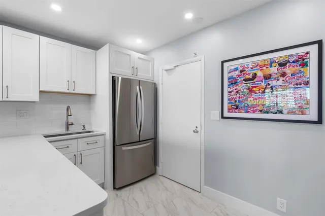 a kitchen with stainless steel appliances granite countertop a stove and a microwave