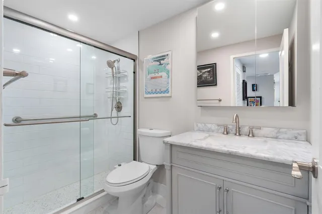 a bathroom with a granite countertop sink and a vanity