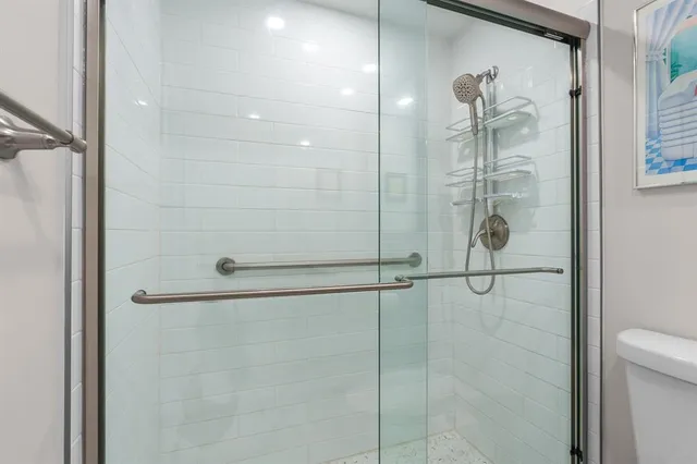 a bathroom with a shower and a sink