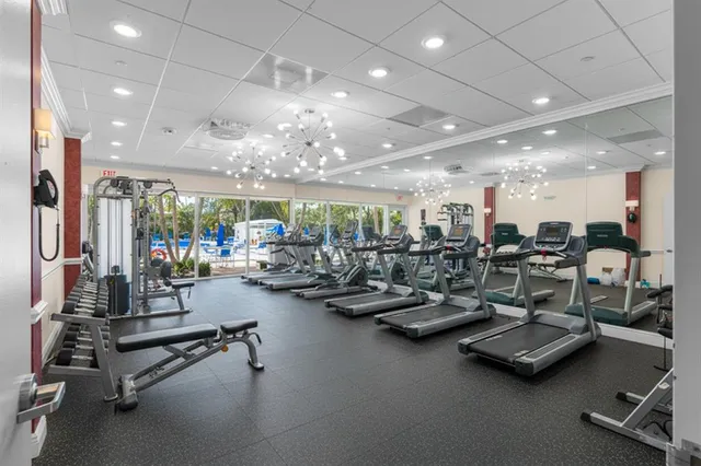 a kitchen with a sink a stove and chairs