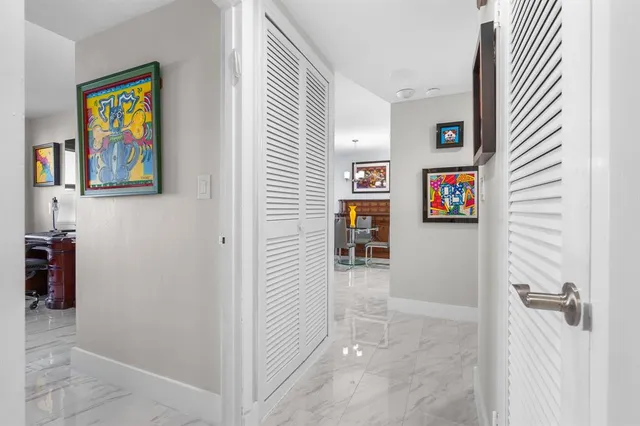 a living room with furniture a flat screen tv and floor to ceiling window
