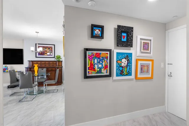 a living room with furniture a large window and a flat screen tv