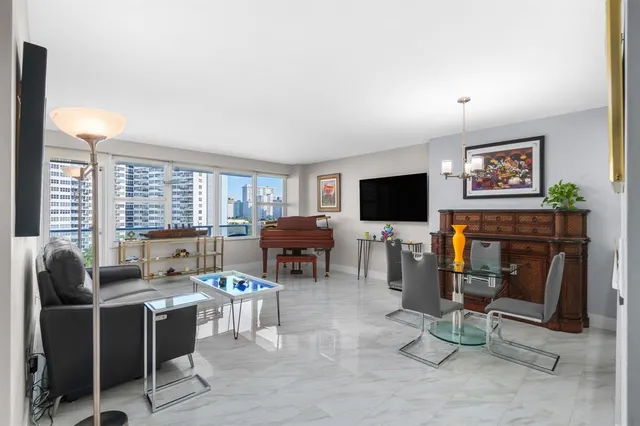a living room with furniture and kitchen view