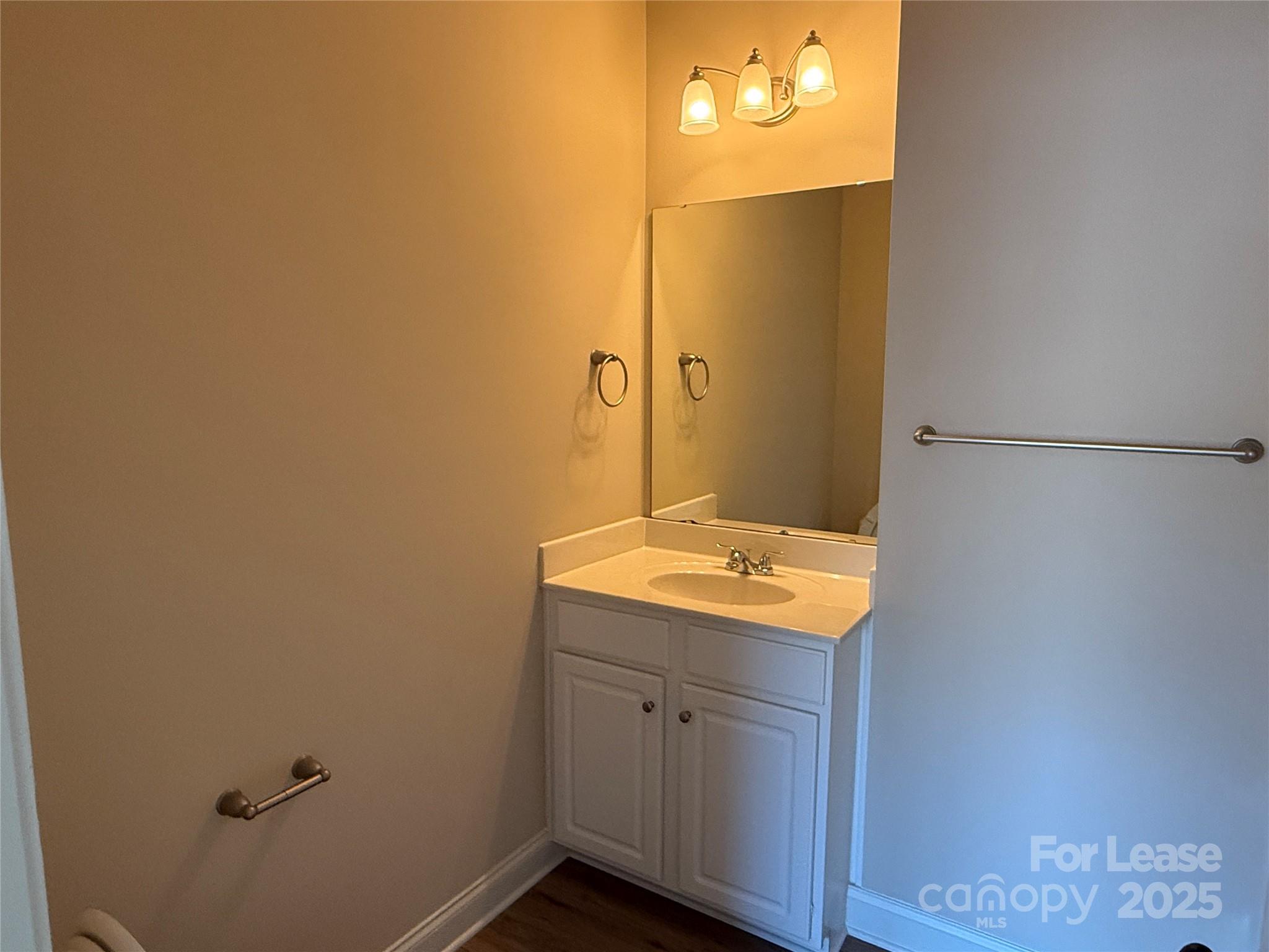 371 Beacon Street Northwest Concord, NC 28027 - Photo 12 of 16 a bathroom with a granite countertop sink and a mirror