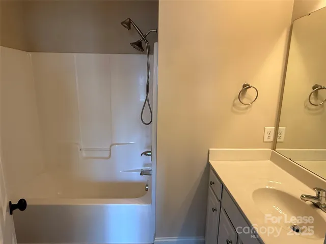a bathroom with a granite countertop sink a toilet and bathtub