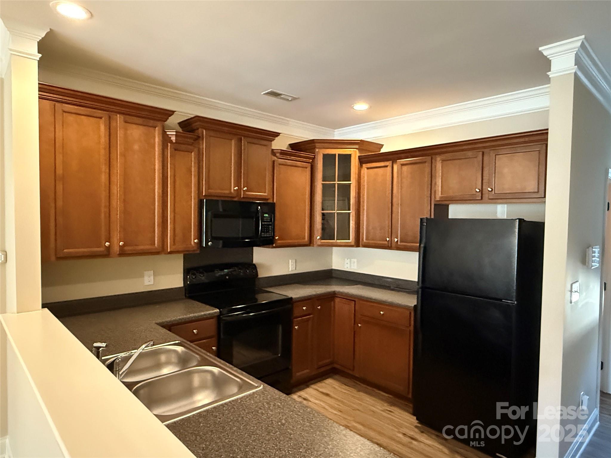 371 Beacon Street Northwest Concord, NC 28027 - Photo 4 of 16 a kitchen with a refrigerator and a sink