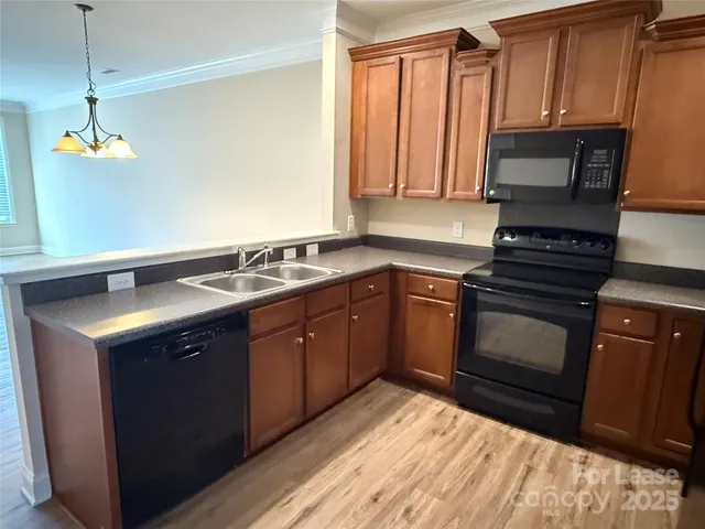 a kitchen with a sink stove and microwave