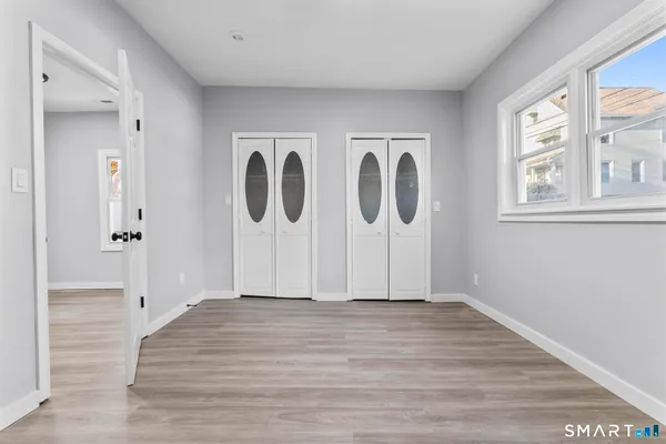 a view of room with window and hardwood floor