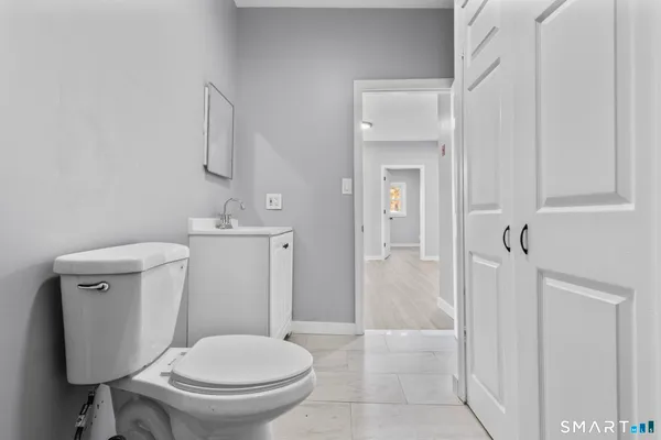 a white toilet sitting next to a bathroom sink