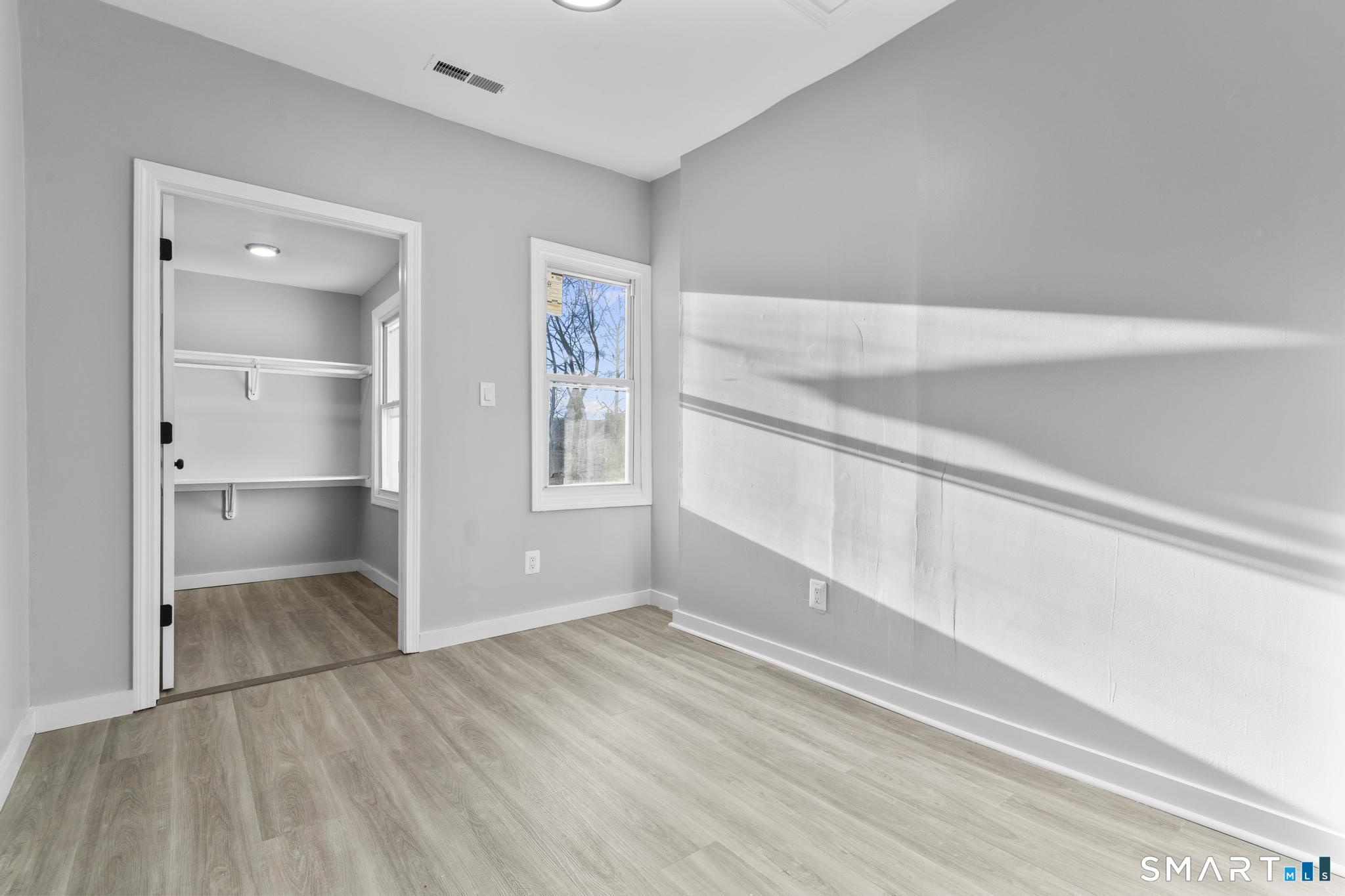 257 North State Street Ansonia, CT 06401 - Photo 17 of 36 a view of an empty room with window and wooden floor
