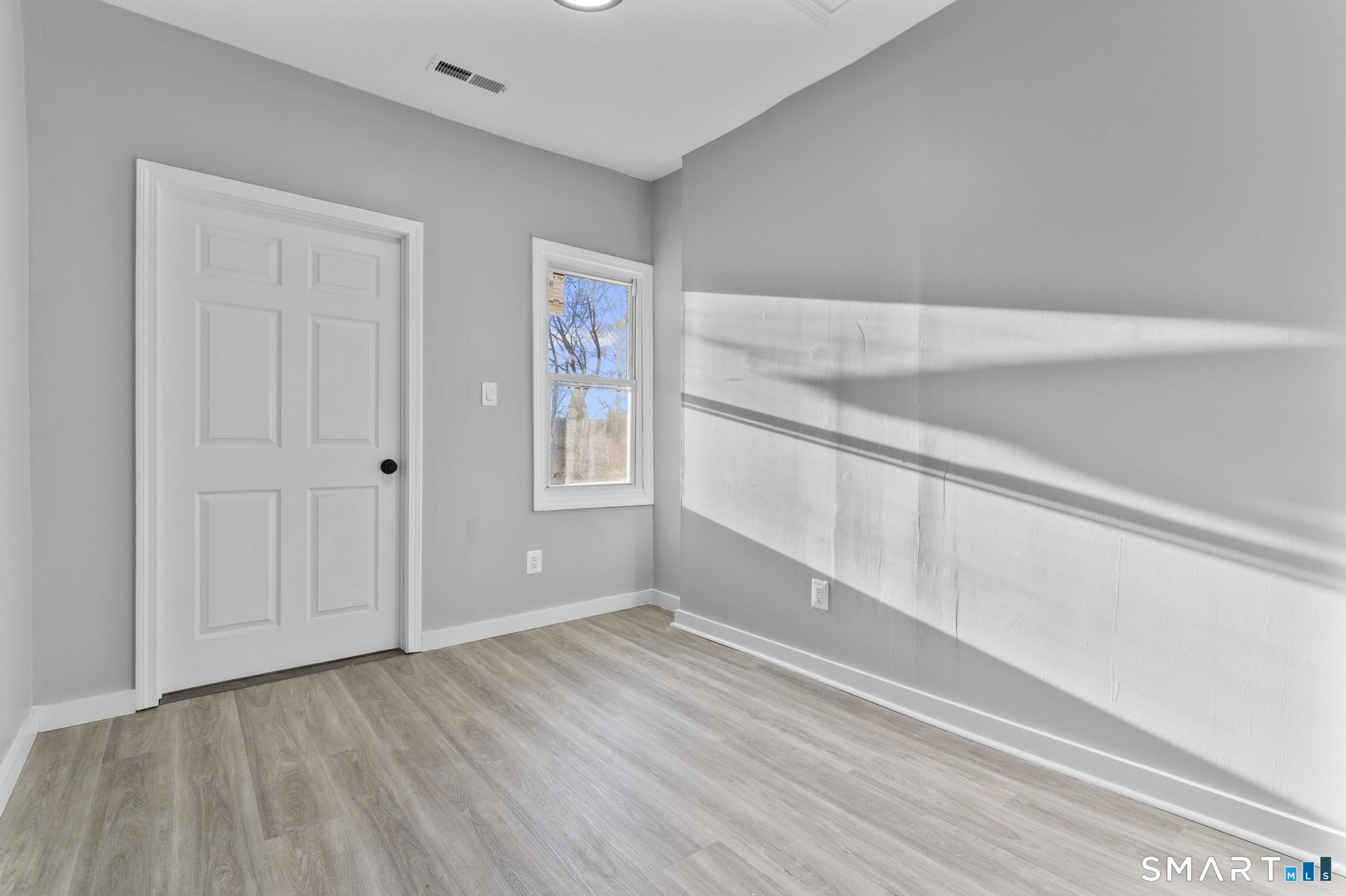 257 North State Street Ansonia, CT 06401 - Photo 18 of 36 a view of an empty room with wooden floor and closet