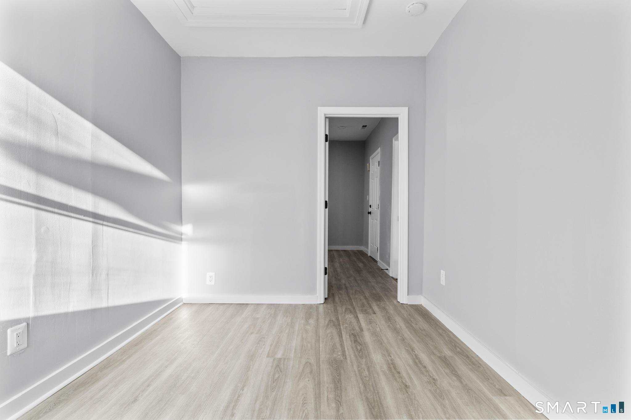 257 North State Street Ansonia, CT 06401 - Photo 20 of 36 a view of a hallway with wooden floor and a window