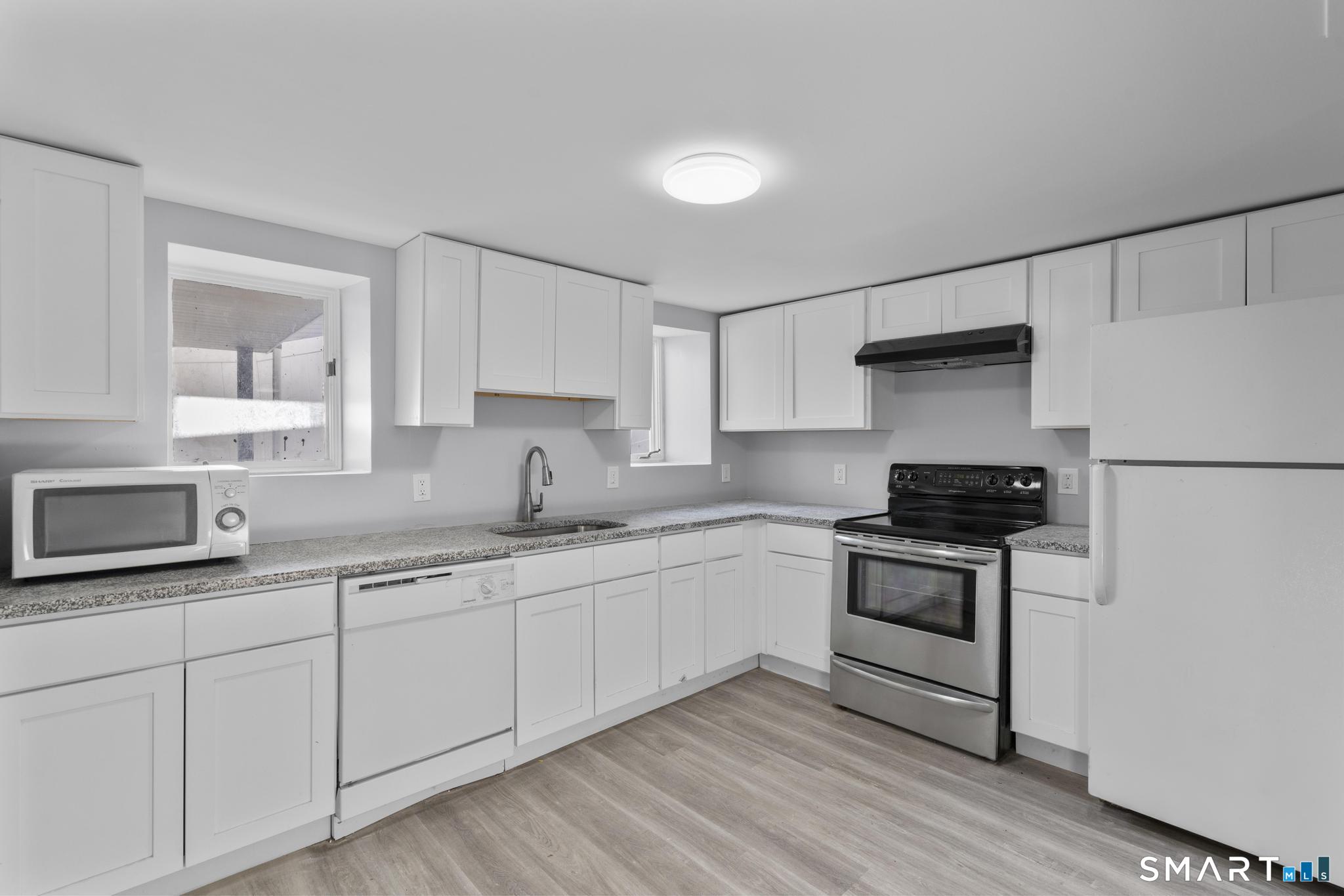 257 North State Street Ansonia, CT 06401 - Photo 24 of 36 a kitchen with stainless steel appliances granite countertop a sink stove and refrigerator