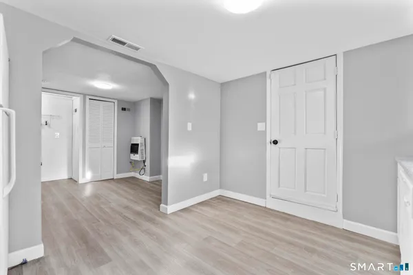 a view of an empty room and wooden floor