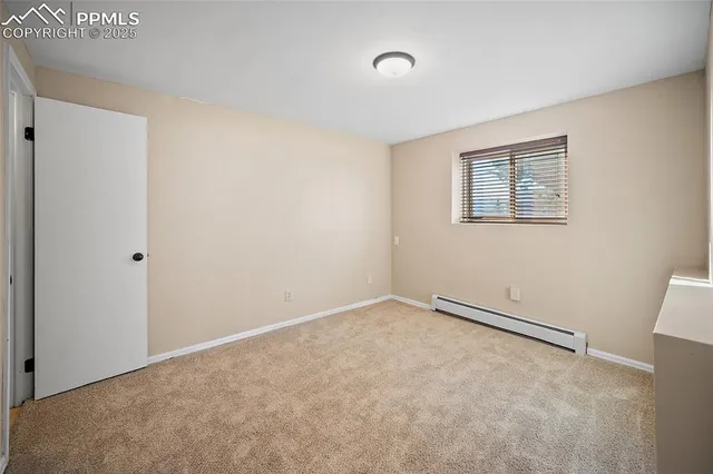 a view of a hallway with bathroom and wooden floor