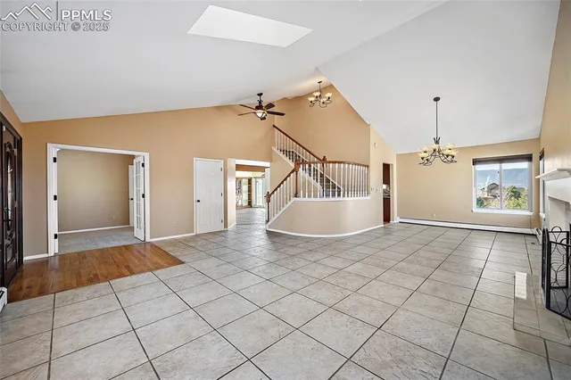 a view of a livingroom with wooden floor and furniture