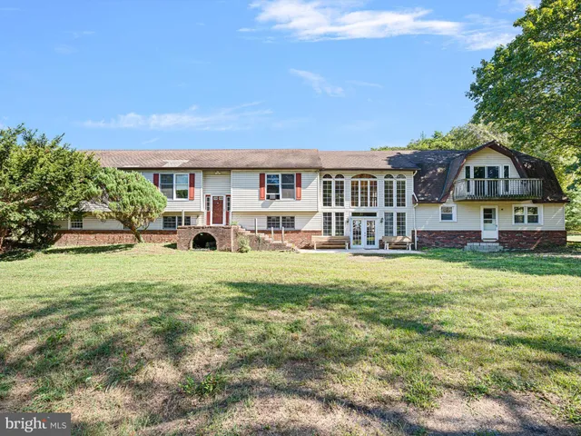 a front view of a house with a yard table and chairs