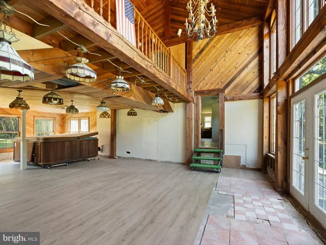 a view of a livingroom with wooden floor and cabinet