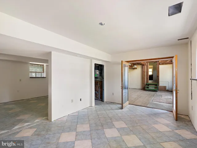 a spacious bedroom with a large bed and large windows