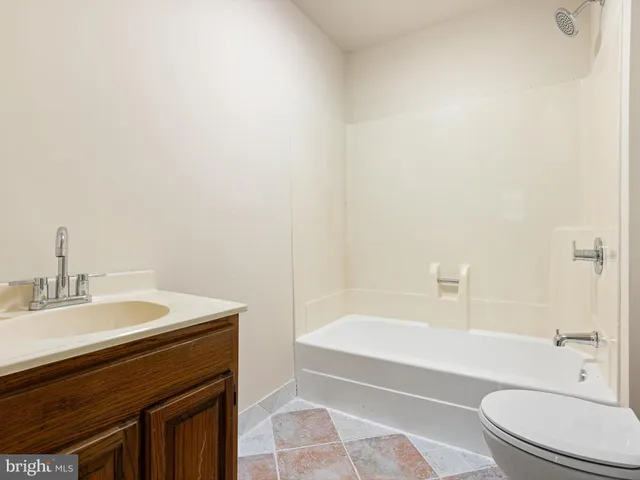 a bathroom with a sink a toilet and bathtub