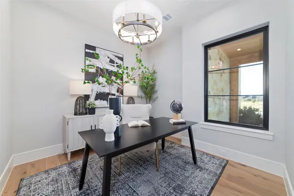 a view of a dining room with furniture and a window