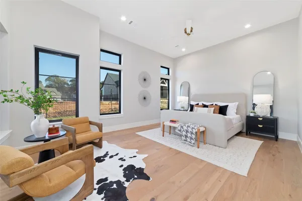 a bedroom with furniture and a large mirror