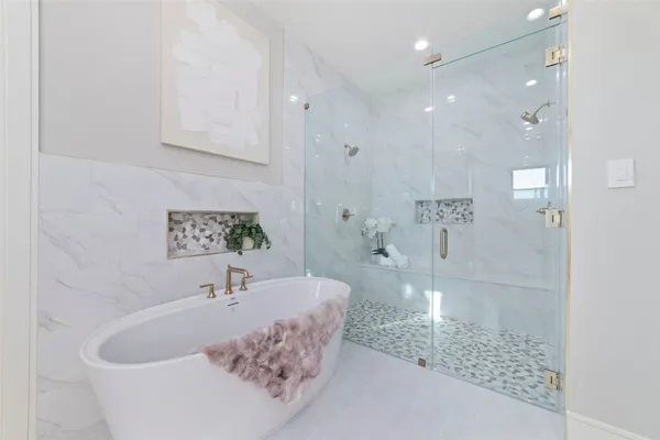 a bathroom with a bathtub and shower