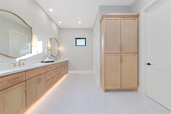 a bathroom with a double vanity sink and a mirror