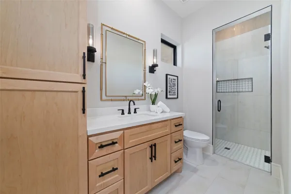 a bathroom with a double vanity sink toilet and shower