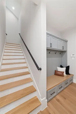 a view of a hallway with wooden floor and staircase