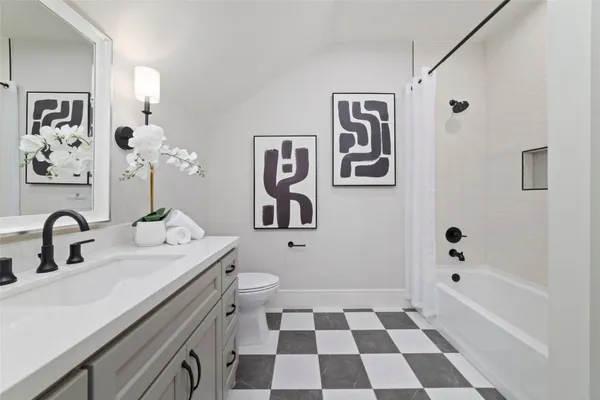 a bathroom with a sink a mirror a toilet and a bathtub
