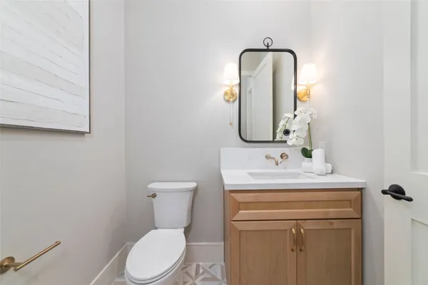 a bathroom with a toilet sink and mirror