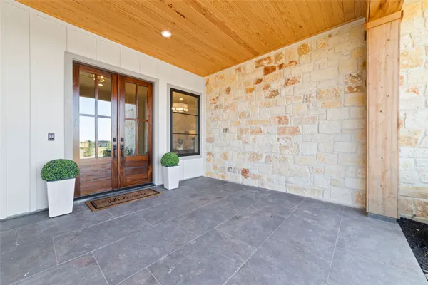 a view of an entryway with wooden floor and windows