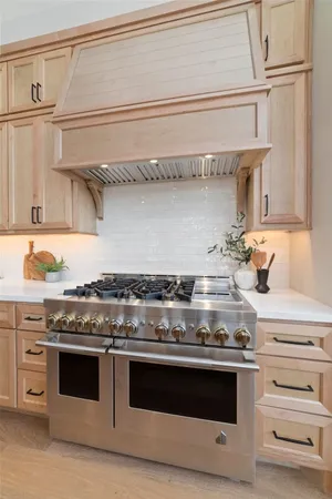 a stove top oven sitting inside of a kitchen