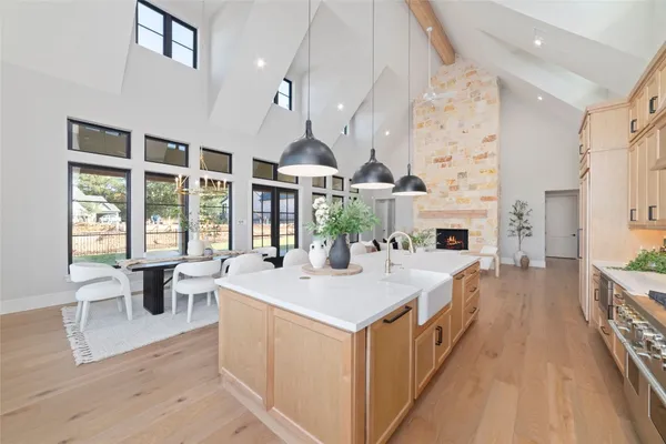 a large white kitchen with a large window