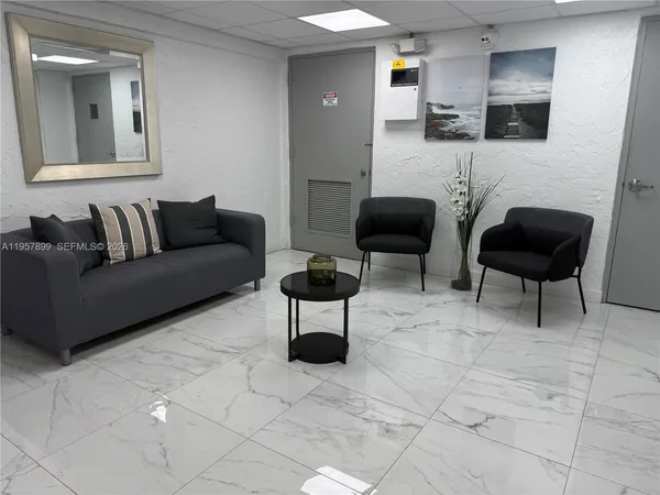 a living room with furniture and a mirror