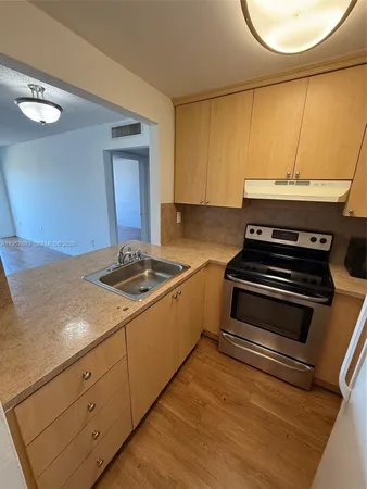 a kitchen with granite countertop a stove and a microwave