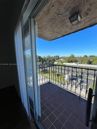 a view of balcony with a floor to ceiling window and wooden fence
