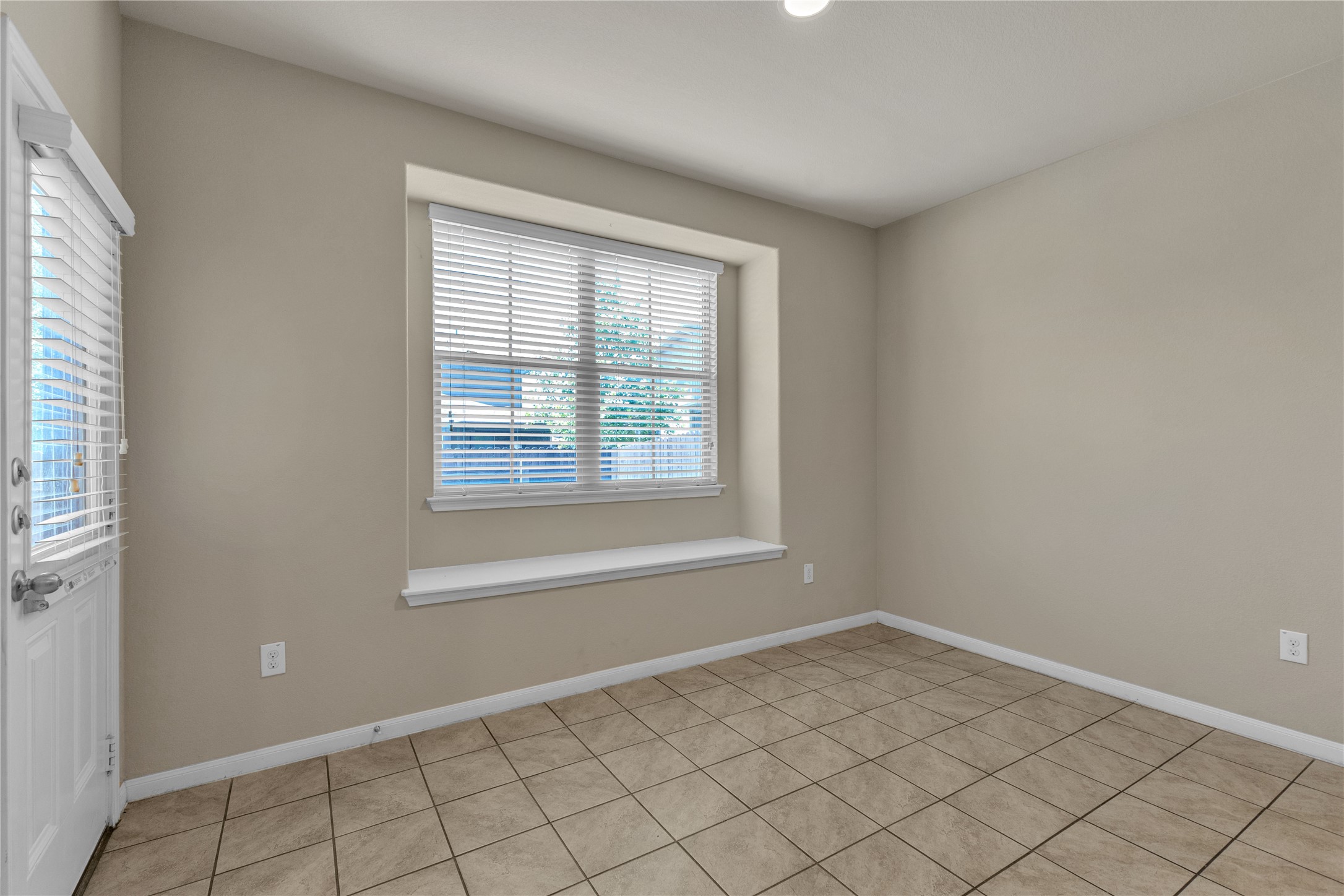 2880 Donnell Drive, Unit 2003 Round Rock, TX 78664 - Photo 28 of 31 Neutral tone walls with white trim and ceramic tile flooring