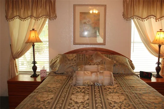 a bed sitting in a bedroom next to a window