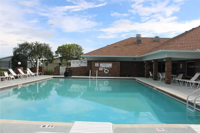 a view of a house with pool table and chairs