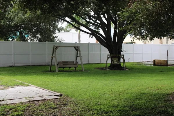 a view of a backyard with large trees