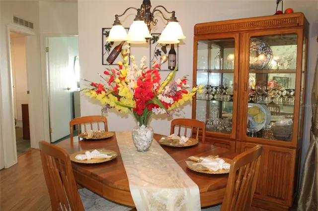 a dining room with furniture and wooden floor