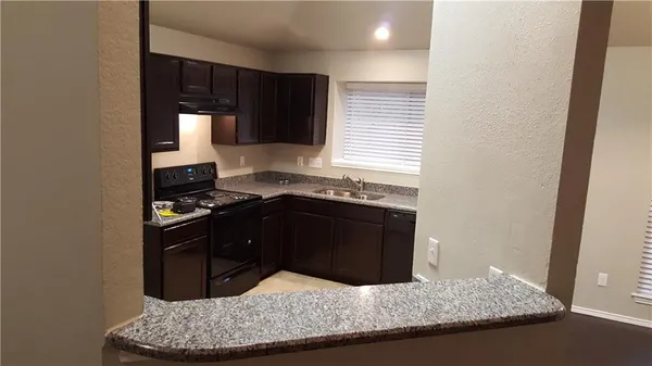 a kitchen with a sink and a stove