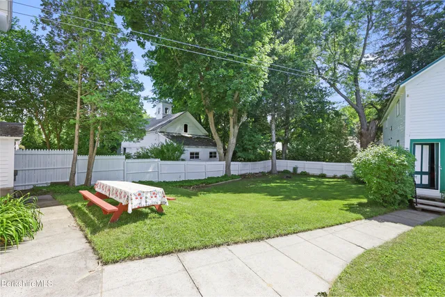 a view of backyard with a garden and trees