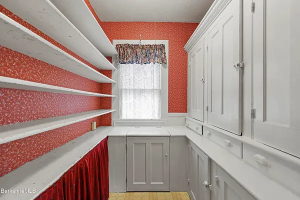 a kitchen with a sink cabinets and a window