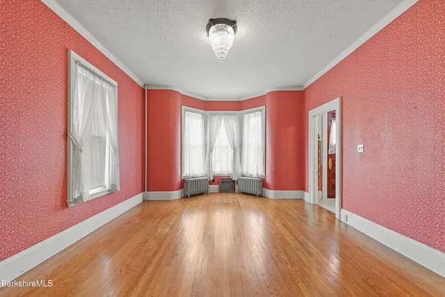 a view of a livingroom with wooden floor and a window